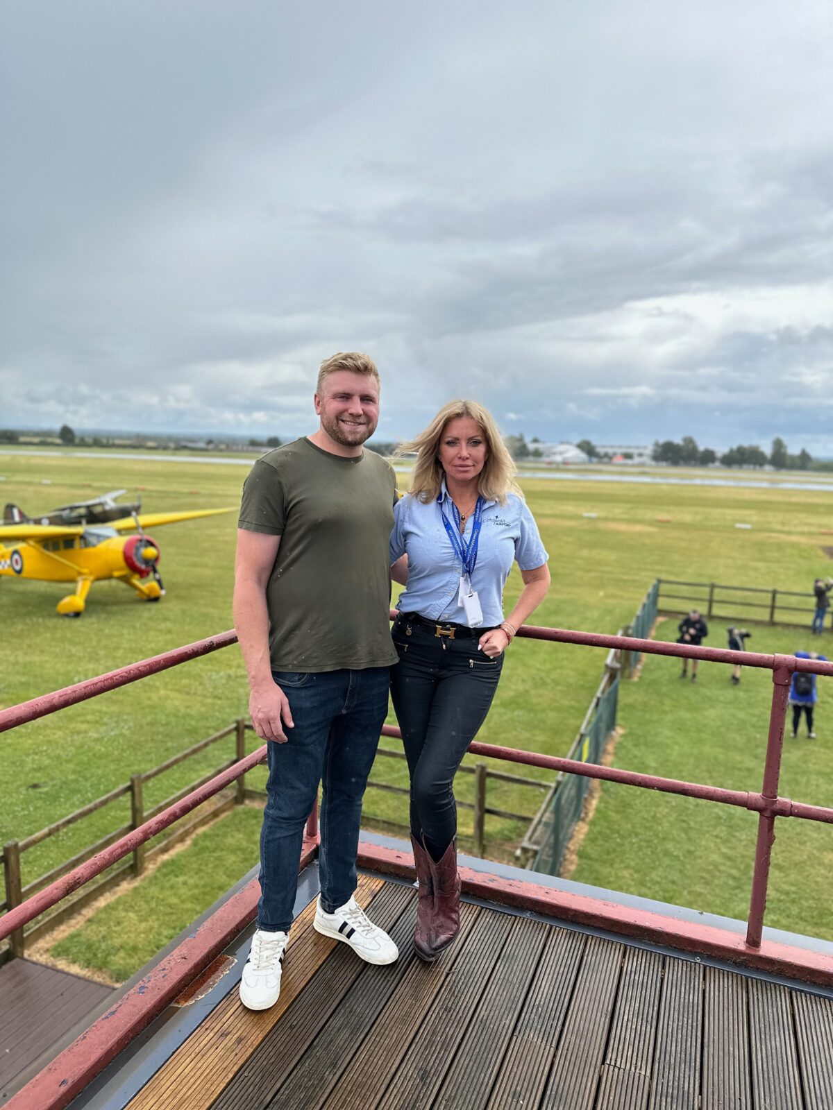 Michael Wrona, Fairford Rugby Club, and Suzannah Harvey, CEO Cotswold Airport, celebrate the signing of a sponsorship deal at Cotswold Airport.